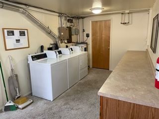 Coin-operated laundry on site has large countertop for folding laundry.